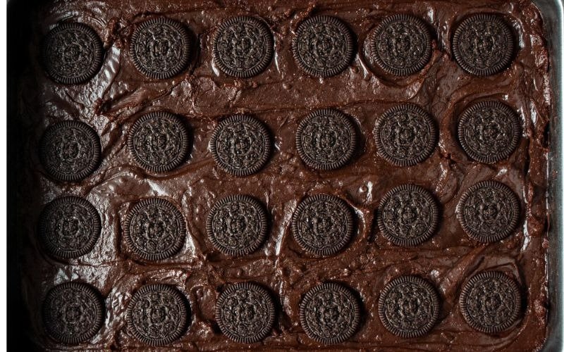 Press Oreos gently into the brownie batter in a single layer